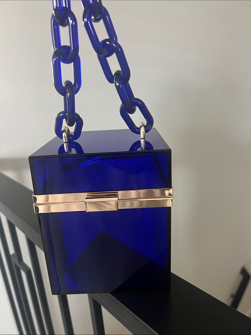Blue acrylic square bag with link handle.